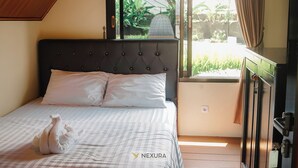 A bedroom with a bed, a window, and a view of greenery. - The Kotenang (Wonosobo)