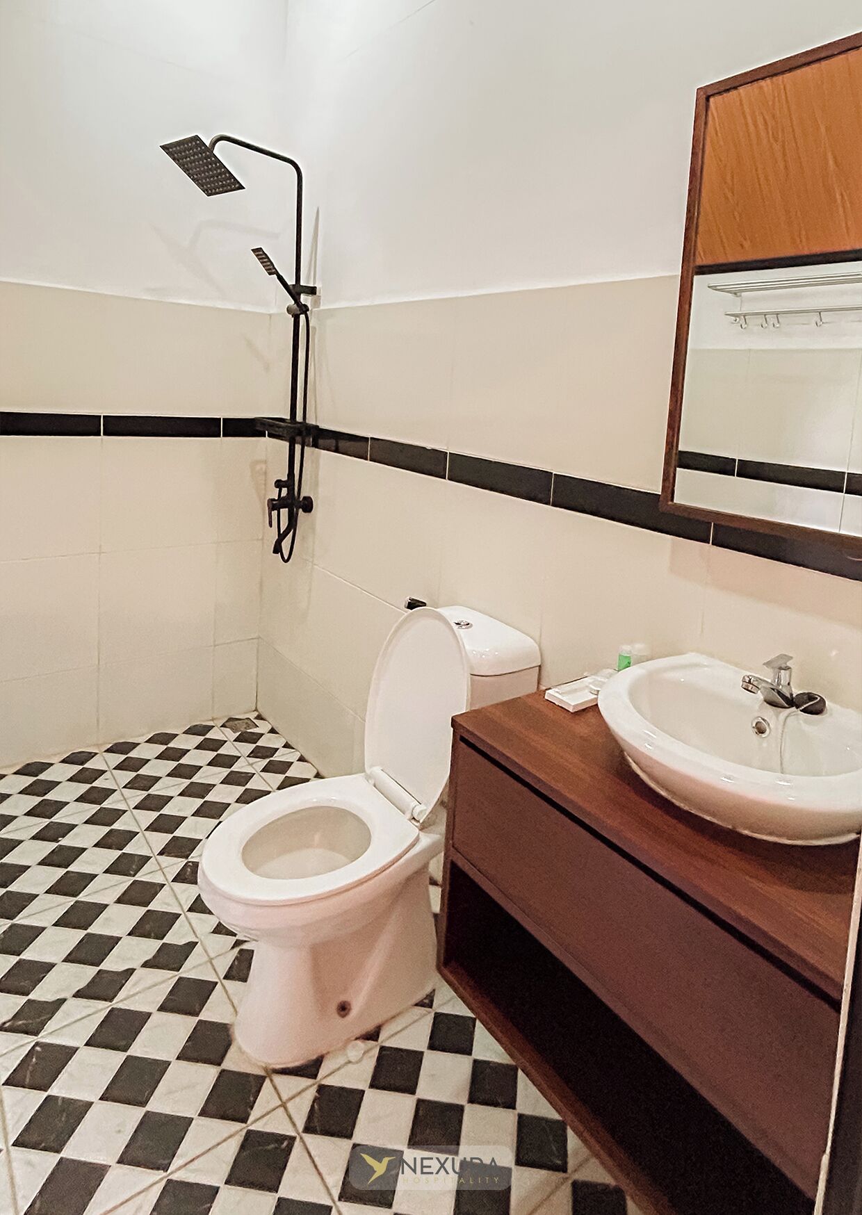 A bathroom with a white toilet, a sink, and a shower.