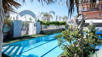 Seasonal outdoor pool, open 9:30 AM to 6:00 PM, pool umbrellas