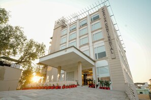 A modern hotel with a covered entrance, multiple floors, and a sign reading "SHIVA CONTINENTAL". - "The Shiva Continental" , Dehradun - A unit of The Chacha Shri Group (Dehradun)