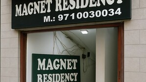A building entrance with a sign reading "MAGNET RESIDENCY" and a directional arrow. - Magnet Residency (New Delhi)