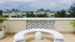A rooftop terrace with a white bench and potted plants. - Tranquil Villa Apartment in Papa Remo Village-2326 (Watamu)