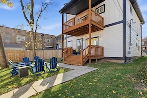 A two-story house with a wooden deck and outdoor seating area. - Family 4BR Retreat with Games and Fun for ALL (Indianapolis)