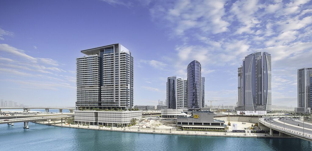 A modern cityscape with high-rise buildings, a bridge, and a waterfront.
