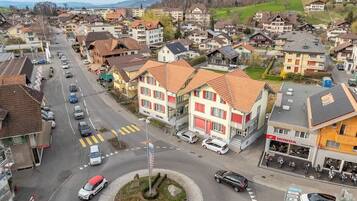 A town square with a roundabout, surrounded by residential buildings and a Honda dealership.