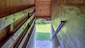 A wooden staircase leading to an outdoor area with a deer head mounted on the wall. - With Hot Tub, Sauna, Garden|with View near Gondola (Diemtigen)