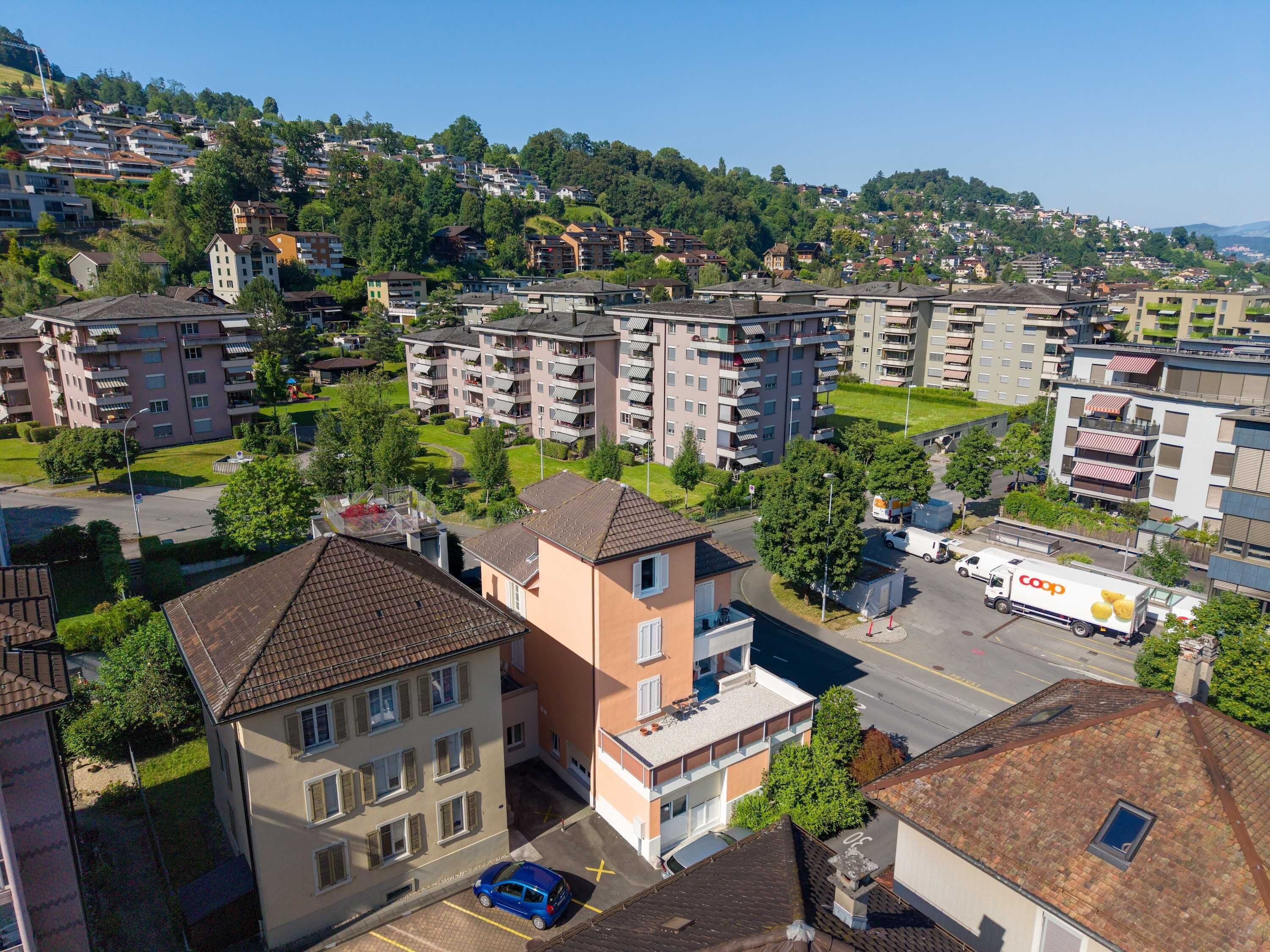 A residential area with multi-story apartment buildings, a parking lot, and a visible commercial truck.