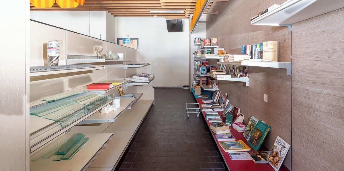 A library with bookshelves, reading tables, and a clear pathway.