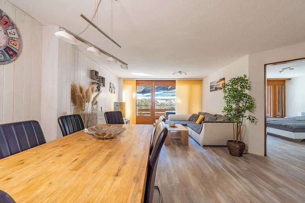 Bright open-plan living and dining area with balcony access