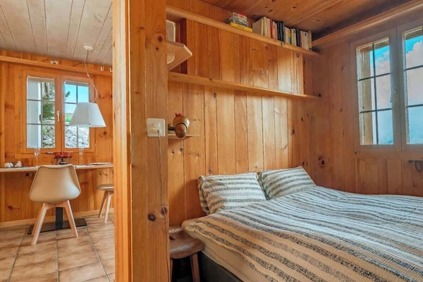 Another bedroom angle showing cozy details and alpine atmosphere.