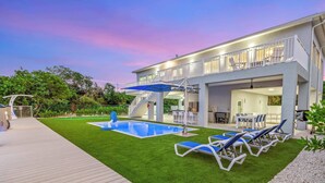 A modern house with a pool, outdoor furniture, and a covered patio area. - Saltwater Social ~ Game Room ~ Pool ~ Dock ~ Views (Marathon)