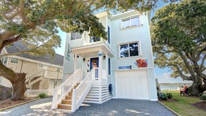 A two-story house with a front porch, a staircase, and a garage.