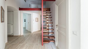 A staircase with a red handrail leading to an upper floor. - Central City Apartment by Wonderful Italy (Palermo)