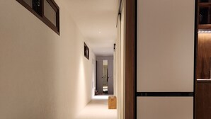 A hallway with a wooden cabinet and a white refrigerator. - Cozy Café Vibes & Timeless Design — Your Tranquil Seoul Hideaway Awaits (Seoul, , Yongsan-gu)