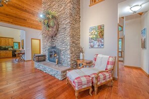 Living room with stone fireplace - Escape to Sugar Pine Sunset! A spacious mountain retreat with stunning sunset views, luxe finishes, a private spa, and endless entertainment across three beautifully designed levels. (Shaver Lake)