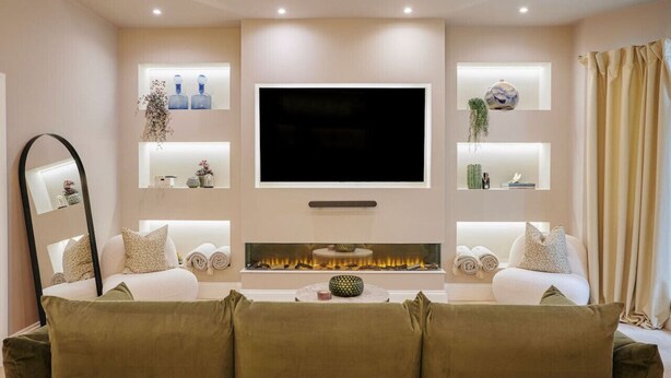 A modern living room with a flat-screen TV, a fireplace, and a sofa. - Beautiful Fulham Townhouse with a bar & pool table (Parsons Green, London, UK)