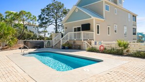 A two-story house with a swimming pool, a covered patio, and a hot tub. - Salty Daze- Private pool & hot tub, pet friendly, family friendly! (Cape San Blas)