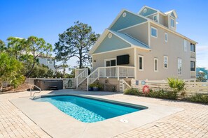 A two-story house with a swimming pool, a covered patio, and a hot tub. - Salty Daze- Private pool & hot tub, pet friendly, family friendly! (Cape San Blas)