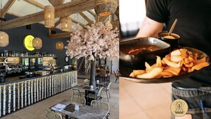 L’intérieur d’un restaurant, avec un bar, des tables et une personne qui sert les plats.