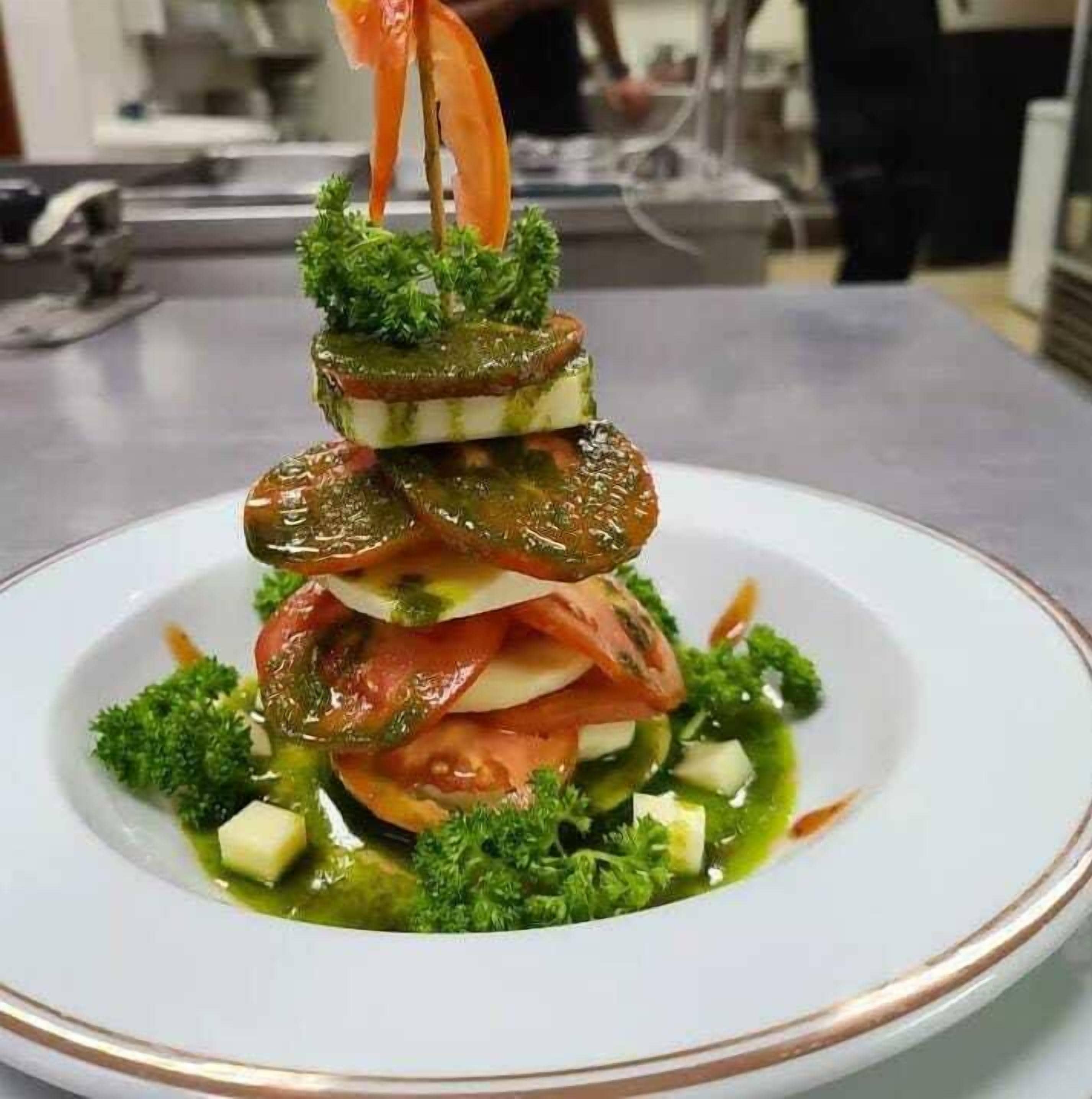 A dish with layered ingredients on a white plate.