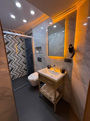 Shower, hair dryer, slippers, towels