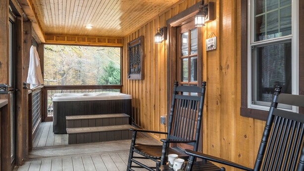 A wooden cabin with a hot tub, wooden deck, and two rocking chairs. - BEARLY LIVIN!  NEW CABIN ON 2 ACRES OF PRIVATE SMOKIES TROUT STREAM!  WOW !! (Cosby)