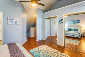A bedroom with a bed, a large mirror, and a ceiling fan. - Golf, Gamble & Deep-sea Fish: Little River Condo (Little River)