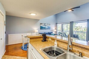 A kitchen with granite countertops, a stainless steel sink, and a coffee maker. - Golf, Gamble & Deep-sea Fish: Little River Condo (Little River)