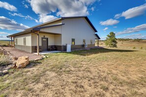 A large, single-story building with a flat roof and a covered porch area. - Trail Access & Scenic Views! Rural Hot Springs Gem (Hot Springs)