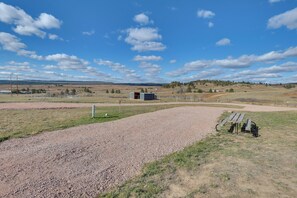 A gravel path leading to a fenced area with a bench and a small building. - Trail Access & Scenic Views! Rural Hot Springs Gem (Hot Springs)
