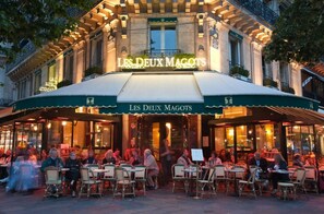 A restaurant named 'Les Deux Magots' with outdoor seating and a classic architectural facade. - IMMERSE YOURSELF IN THE AUTHENTIC PARISIAN LIFESTYLE AT BLVD SAINT GERMAIN (Paris)