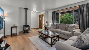 A modern living room with a sofa, coffee table, and a fireplace.