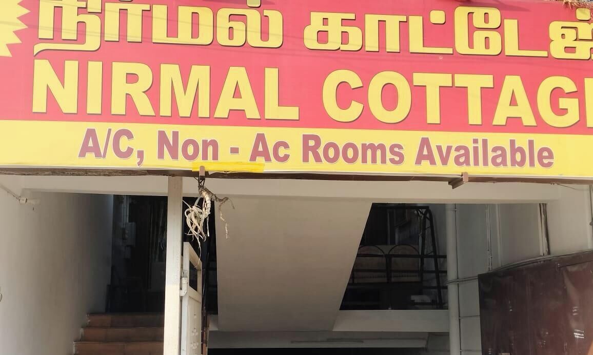 A signboard for Nirmal Cottage advertising A/C, Non-AC rooms.