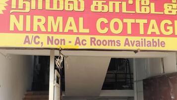 A signboard for Nirmal Cottage advertising A/C, Non-AC rooms.