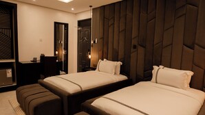 Une chambre d’hôtel moderne, dotée d’un grand lit, d’un bureau et d’un coin salon.
