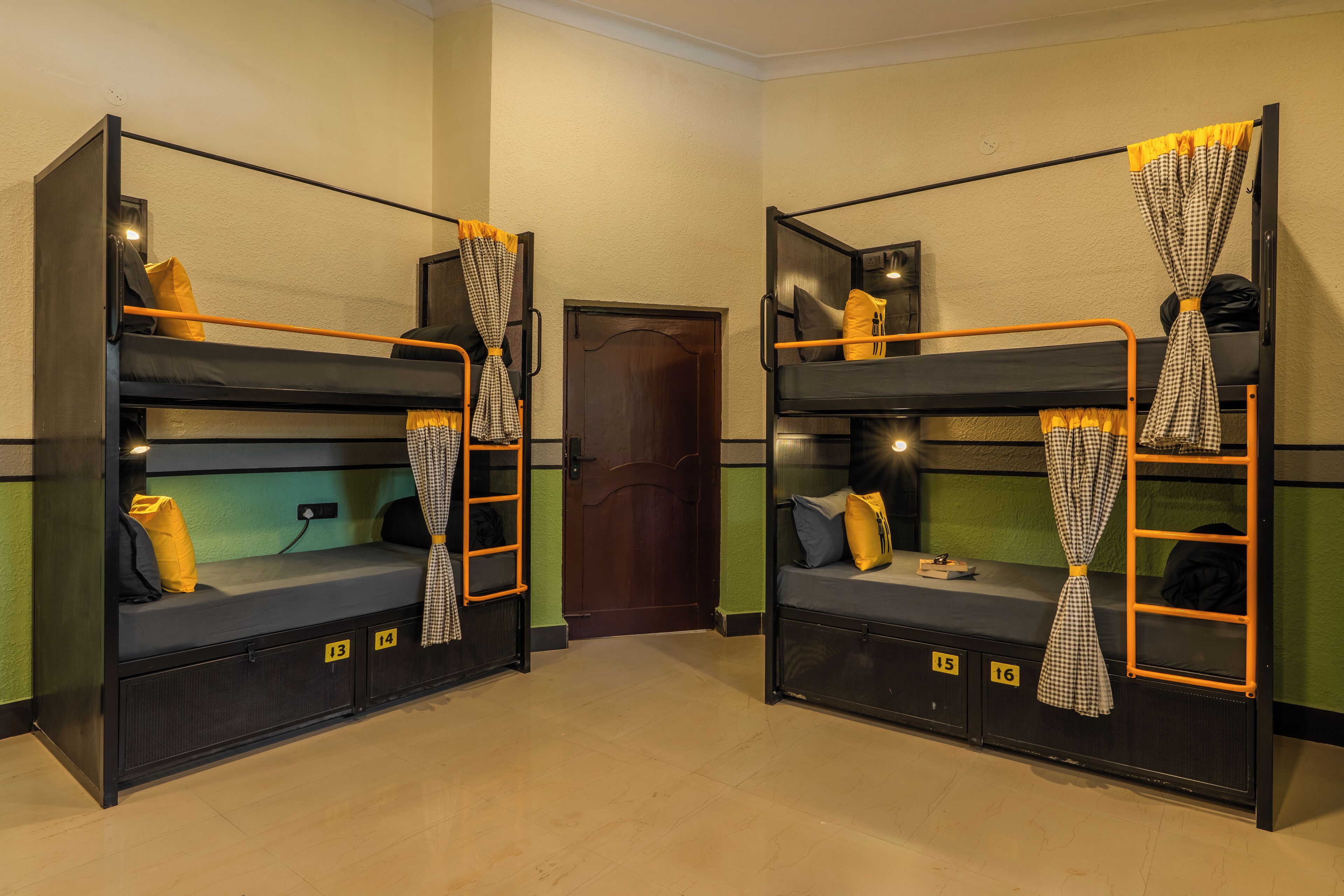 Two bunk beds with storage drawers, a door, and a light fixture.