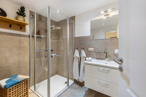 A modern bathroom with a glass shower enclosure, a sink, and a mirror. - Holiday Apartment 'Auf'm Kornboden', 120 sqm, 2 Bedrooms, Max. 4 Guests (Lennestadt)