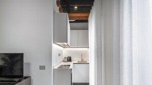 A modern kitchen with white cabinets, a stainless steel sink, and a coffee machine. - Palace Of The Elect Green Apartment R&R (Venecia)