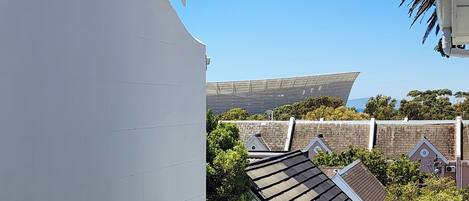 A modern building with a flat roof and a large, flat, white facade.