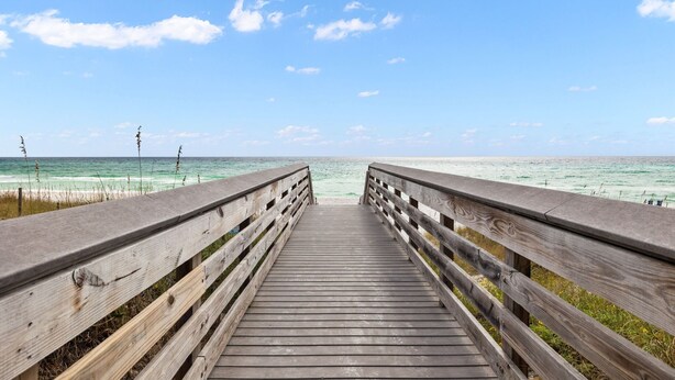 A wooden boardwalk leading to a beach with clear skies and ocean views. - Spacious Retreat Made for Memory-Making Moments w/ Pool, Spa, and Game Room (Inlet Beach)