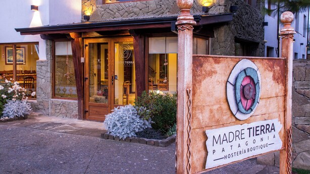 A stone building with a sign reading "Madre Tierra Patagonia Hostería Boutique." - Standard Double Room (Queen Bed) (El Calafate)