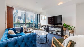 Comfortable living area featuring soft seating and a large smart TV - Southbank River View Apartment - Melbourne CBD (Southbank)