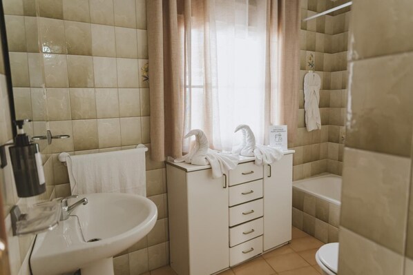 Bathtub, hair dryer, towels, soap