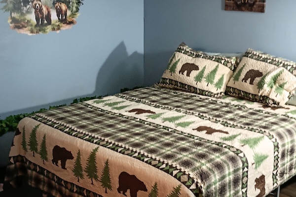 Unwind in our inviting sleeping quarters, featuring a warm, nature-theme room.