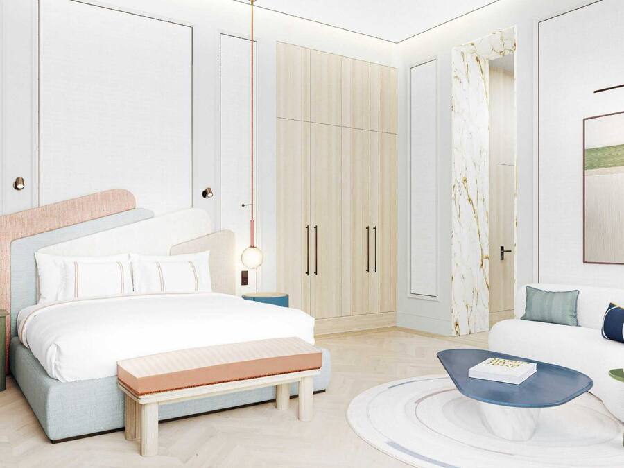 Una habitación de hotel moderna con una cama grande, un sofá, una mesa de centro y un armario.