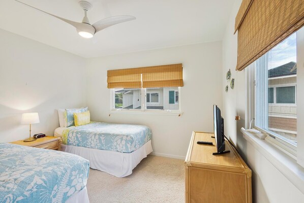 A bedroom with two beds, a ceiling fan, a TV on a wooden cabinet, and a window with blinds. - Summer Deal Kona Ocean View Villa with Pool Hot Tub and Beach Gear (Kailua-Kona)