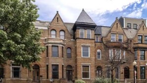 A row of Victorian-style brick townhouses with gabled roofs and arched windows. - 7 bdrm 7 bth 3 kitchens NW DC w/parking & balcony (Washington)