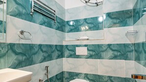 A bathroom with a toilet, sink, and shower. - Priya Residency Pondicherry (Vanur)
