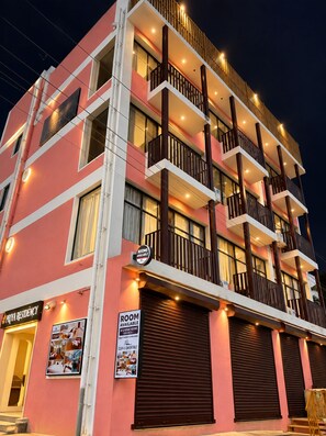 A multi-story hotel with balconies, a sign indicating rooms are available, and a visible entrance. - Priya Residency Pondicherry (Vanur)