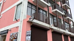 A multi-story building with balconies, a sign indicating rooms are available, and a visible entrance to a property named "PRIVA RESIDENCY". - Priya Residency Pondicherry (Vanur)